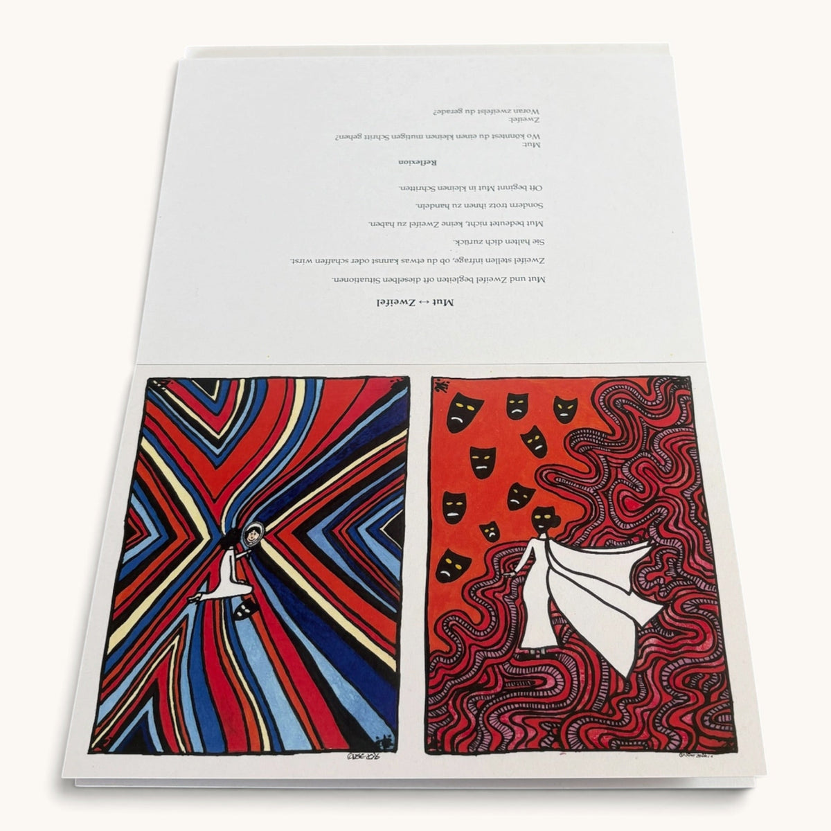 Kartenbuch Dualität aufgeschlagen mit zwei gegensätzlichen Illustrationen